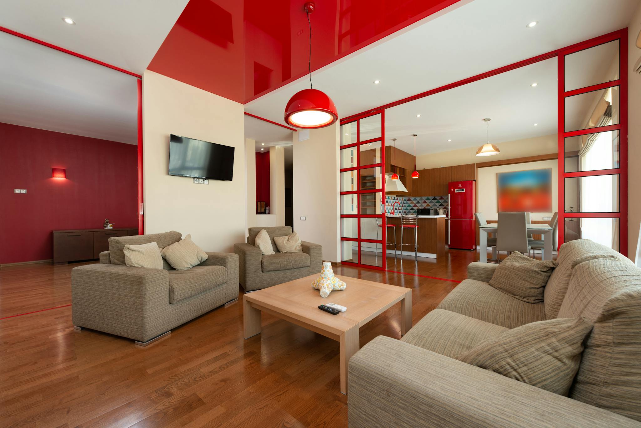 Interior of spacious bright living room with comfortable sofa and armchairs in contemporary flat